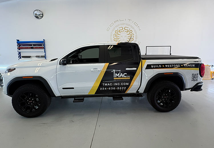 A pickup truck with a commercial wrap